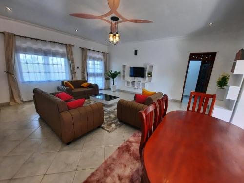 a living room with a couch and a table at Deerwood Family Apartments, Bulenga in Bulenga