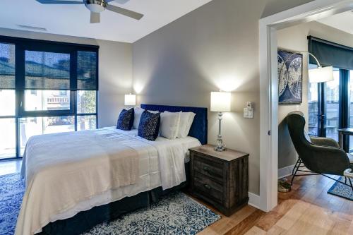 a bedroom with a bed and a chair and a window at 145 Biltmore Avenue Condo 541B0E in Asheville