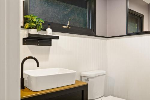 a bathroom with a sink and a toilet at Modern Treetop Cabin by Lake Arrowhead Village in Lake Arrowhead