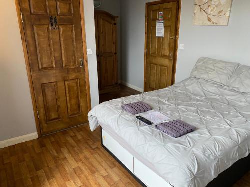 a bedroom with a bed with purple pillows on it at The Old Post Office Public House & Hotel in Halifax