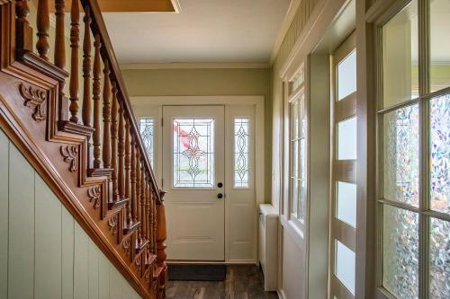 a hallway with a white door and windows at Big River Escape Grandview Manse in Minneiska