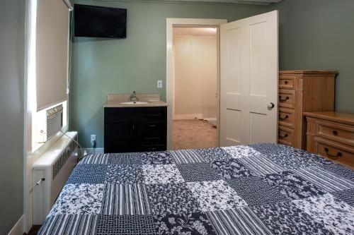 a small bedroom with a bed and a sink at Big River Escape Grandview Manse in Minneiska