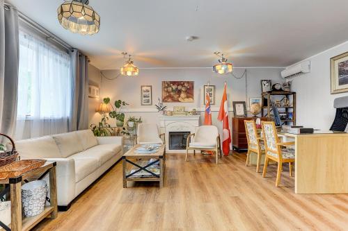 a living room with a couch and a table at Stone Fountain Motel in Fenelon Falls
