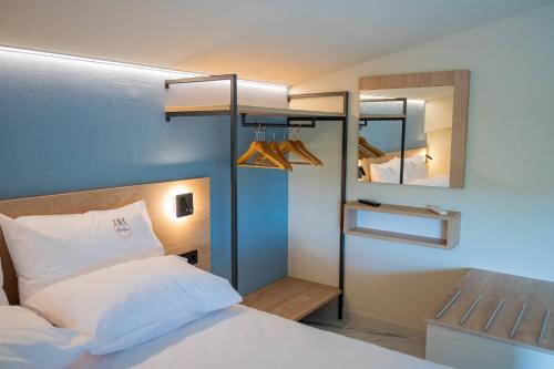 a bedroom with a bed and a mirror at Fay Suites in Flogita