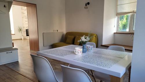 a white table and chairs in a living room at Апартаменти біля Фортеці in Kamianets-Podilskyi