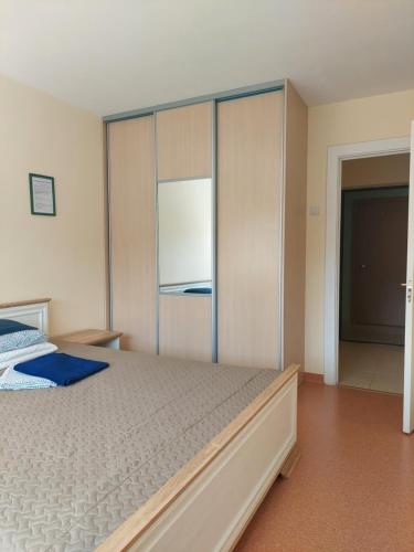 a bedroom with a bed and a sliding glass door at "Veiklus Rietavas" apgyvendinimas in Rietavas