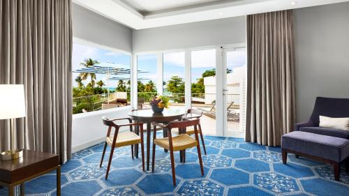 a living room with a table and chairs and a couch at Fairmont El San Juan Hotel in San Juan