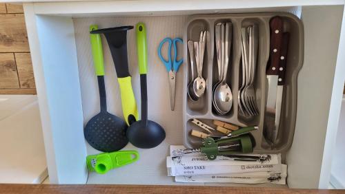 a drawer filled with utensils in a kitchen at Апартаменти біля Фортеці in Kamianets-Podilskyi
