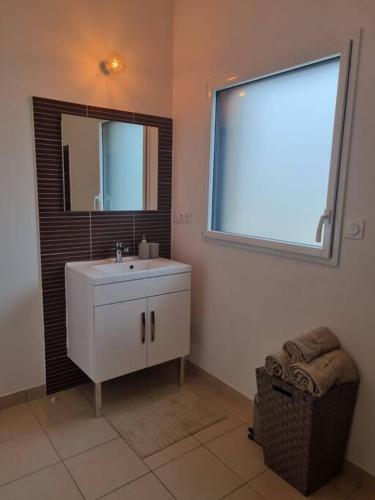a bathroom with a sink and a mirror and a window at VILLA ROSA PARK in Guipavas