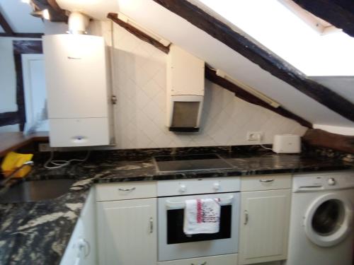 a kitchen with a sink and a stove top oven at ATICO TORRONTERO in Mundaka