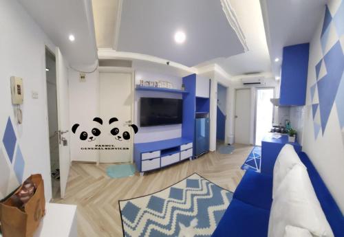 a living room with a panda bear mural on the wall at Apartment Kalibata City by PanBul in Jakarta