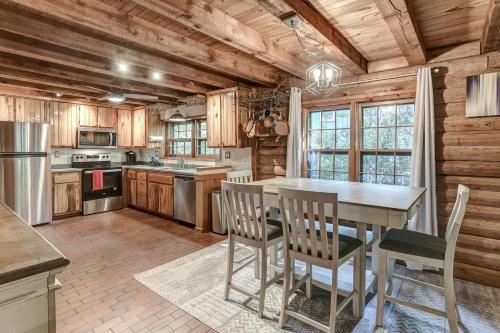 a kitchen with a table and chairs in a cabin at Charming Renovated Cabin with Fireplace in Arden