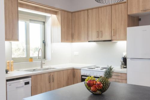 a kitchen with a bowl of fruit on a counter at Alonakia Home Suites in Filiatra