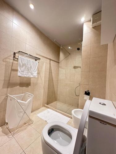 a bathroom with a toilet and a shower at aladnan Chalet alraha village in Aqaba