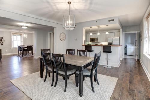 a dining room and kitchen with a table and chairs at 8 Village Lane 200 in Asheville