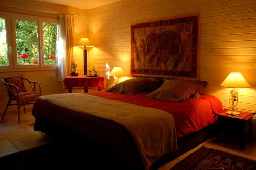 a bedroom with a large bed and two lamps at La Villa Florida in Dieppe