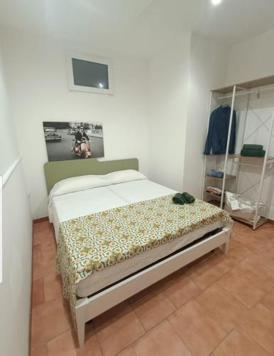 a bedroom with a bed in a white room at Appartamento Borgonuovo in Gallipoli