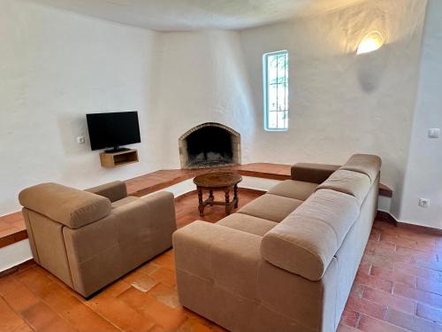 a living room with a couch and a fireplace at Villa Valentina in Carvoeiro