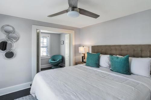 a bedroom with a large bed with green pillows at 237 East Chestnut St in Asheville