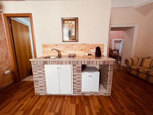 a kitchen with a brick counter with a sink at B&B Porta Grande in Mesagne