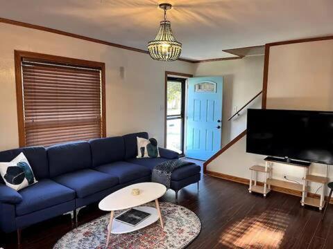 ein Wohnzimmer mit einem blauen Sofa und einem TV in der Unterkunft Jennings in Cuyahoga Falls