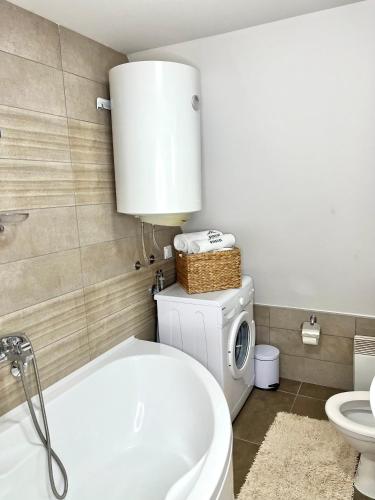 a bathroom with a tub and a toilet and a sink at WoodSide Žabljak in Žabljak