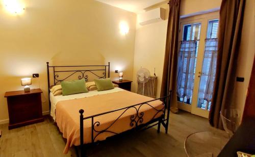 a bedroom with a bed with two green pillows at il Sole di Baggio in Milan