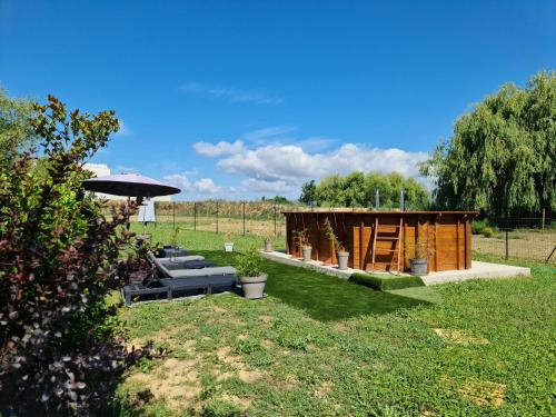 a garden with a wooden shed and an umbrella at MAS GABELYS superbe vue SAINTE VICTOIRE jardin terrasse et piscine in Trets