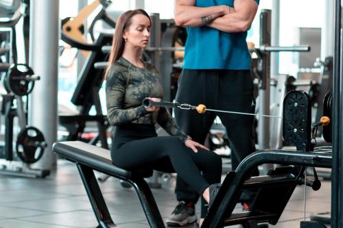 a man and a woman exercising in a gym at Holiday Inn - Suites Kuwait Salmiya by IHG in Kuwait
