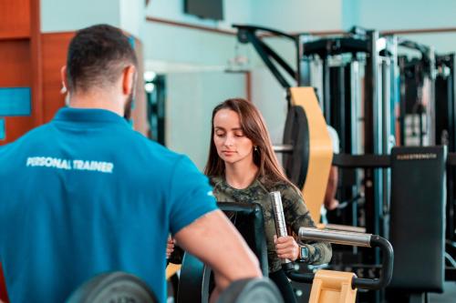 a man and a woman in the gym at Holiday Inn - Suites Kuwait Salmiya by IHG in Kuwait