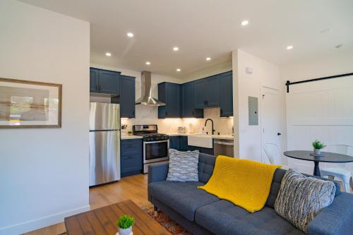a living room with a blue couch and a kitchen at Fern House South Park Craftsman in San Diego