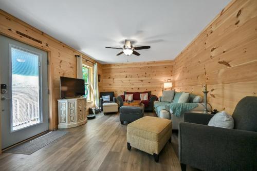 a living room with wooden walls and a ceiling at Goss at Lake Lure in Lake Lure