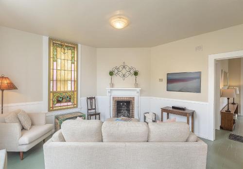 a living room with a white couch and a fireplace at 3893 Sweet Seventeenth home in Pacific Grove