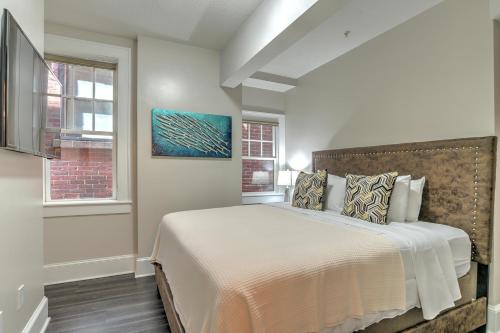 a bedroom with a large bed and a window at Historic King James Unit 5 in Asheville