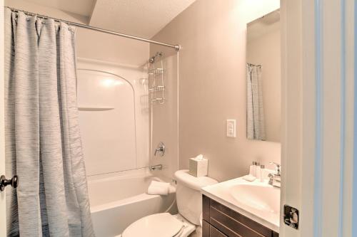 a white bathroom with a toilet and a sink at Historic King James Unit 5 in Asheville