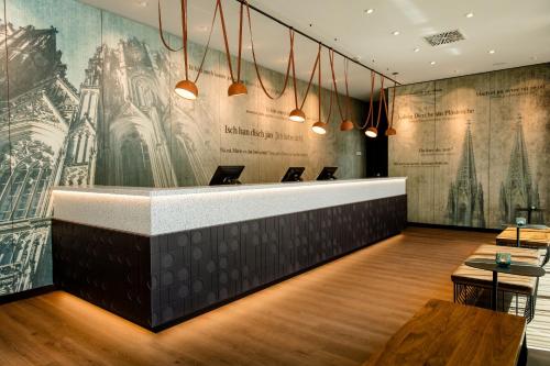 a restaurant with a large mural on the wall at Motel One Köln-Mediapark in Cologne