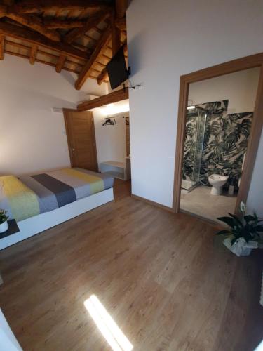 a bedroom with two beds and a mirror at VillaSveva in Sernaglia della Battaglia