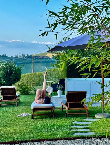a woman laying on a chair in the grass at MiaClara Relais in Alba