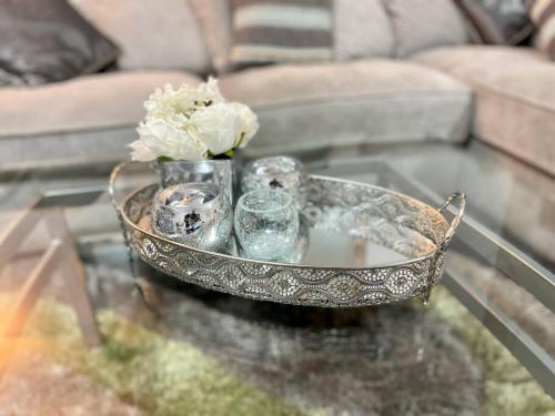 a tray with candles and a vase on a table at Stylish 2 Bed/Bath Apartment in Birmingham
