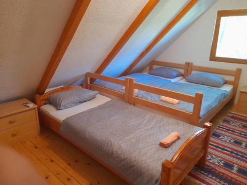 two twin beds in a room with a attic at Pure Nature in Bihać