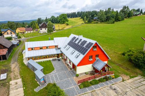 an aerial view of a house with solar panels on it at Penzion Podkůvka in Kořenov