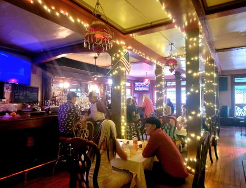 a group of people sitting at a table in a restaurant with lights at Copper Queen Hotel in Bisbee