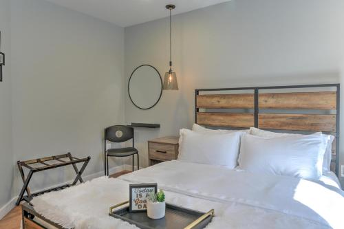 a bedroom with a large white bed with a mirror at 503 Webb Cove Rd in Asheville