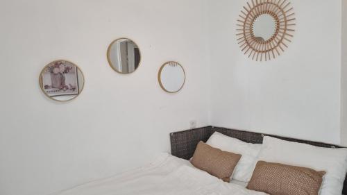 a bedroom with mirrors on the wall and a bed at Stylish Quiet and Central in Rechovot