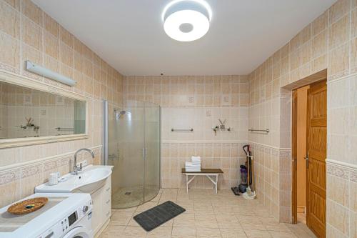 a bathroom with a sink and a shower at Calm and private apartment by Polo Apartments in Kaunas