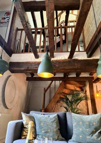 a living room with a blue couch and a staircase at Maison Marcks Champagne in Ay