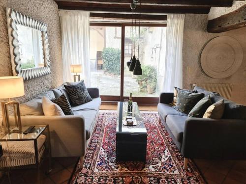 a living room with couches and a coffee table at Maison Marcks Champagne in Ay
