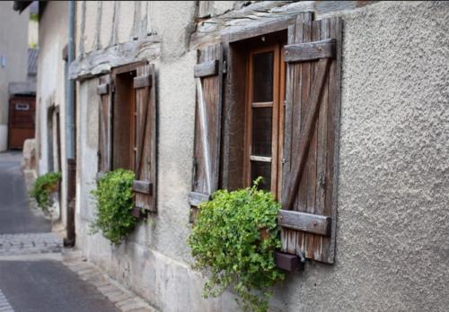 a window of a building with potted plants on it at Maison Marcks Champagne in Ay