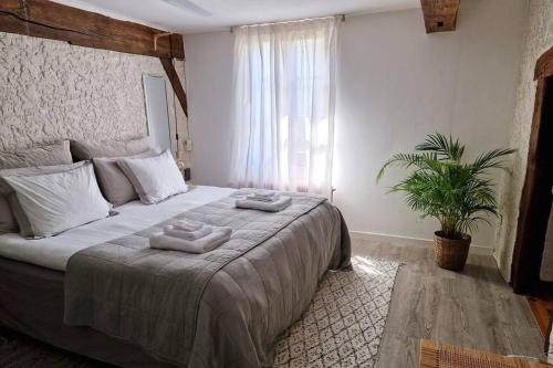 a bedroom with a large bed with two towels on it at Maison Marcks Champagne in Ay