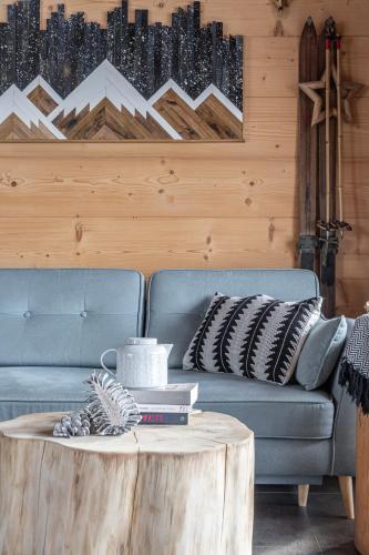 a living room with a couch and a coffee table at Stylowa Chata in Zakopane
